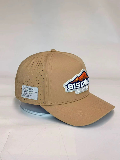 Angled view of tan 915GOLF™ performance golf cap